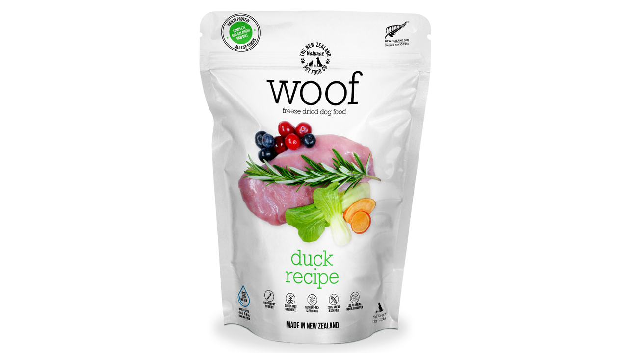 A white bag of WOOF Freeze Dried Duck Dog Food by WOOF - The NZ Natural Petfood Co, with images of raw duck, herbs, and berries on the front to highlight its raw nutrition and natural ingredients.