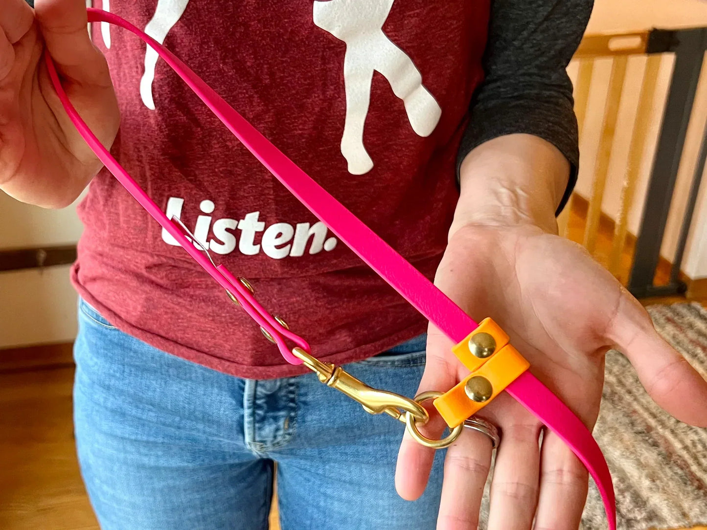 A woman holding a Trailblazing Tails: The Shadow Long Line with SLIDE TAB HANDLE - PRE-ORDER dog leash from Your Whole Dog.