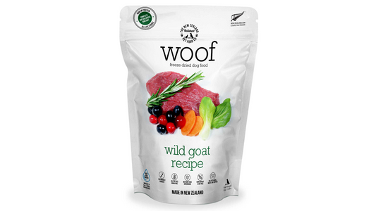 A package of WOOF Freeze Dried Wild Goat Dog Food by WOOF – The NZ Natural Petfood Co, featuring images of raw meat, berries, and vegetables, made with premium New Zealand ingredients like green-lipped mussels.