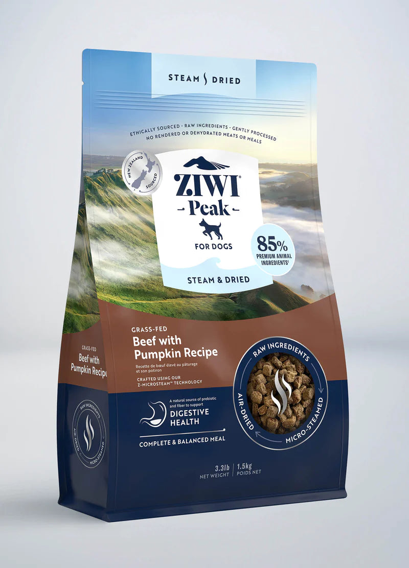 The Ziwi Peak dog food bag features grass-fed beef and pumpkin, promoting optimal digestion. It displays a mountain landscape and highlights its steam-dried, raw nutrition formula.