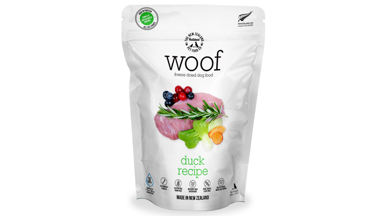A resealable white bag of WOOF Freeze Dried Duck Dog Food by WOOF - The NZ Natural Petfood Co, showing duck, berries, greens, and “Made in New Zealand,” promotes raw nutrition with natural ingredients.