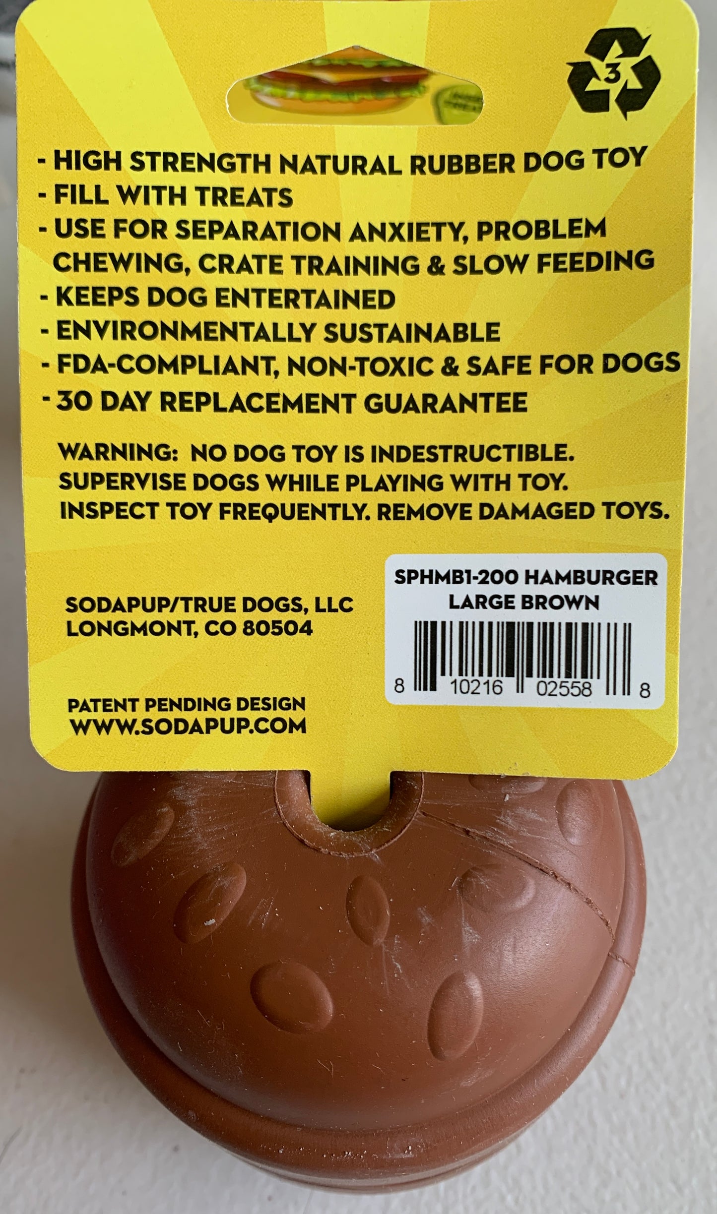 The $10 CLEARANCE Soda Pup HAMBURGER Chew Toy & Treat Dispenser from Your Whole Dog is a durable, eco-friendly brown rubber toy with a tag, perfect for dog enrichment and treats. Labeled "Hamburger Large Brown.