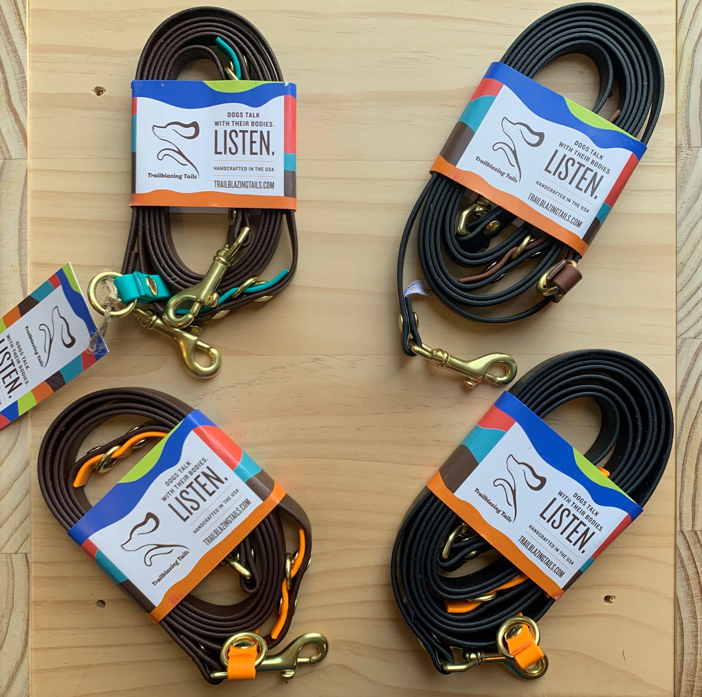 Four Trailblazing Tails: The Sunny leashes on a wooden table.