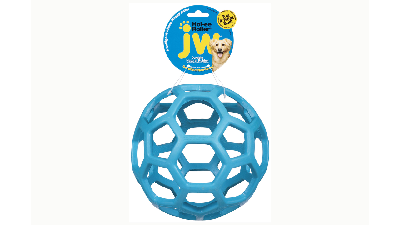The JW Hol-ee Roller by Your Whole Dog is a blue rubber toy with a hexagonal cutout design, complete with a label attached at the top.
