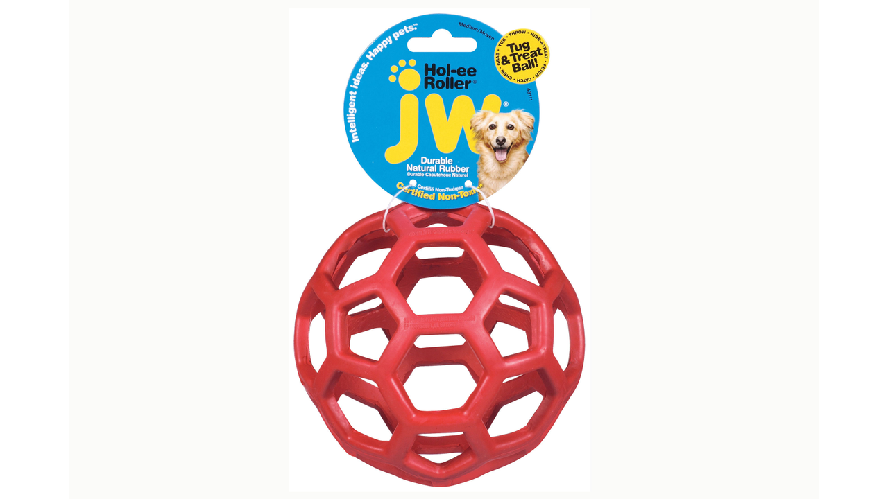 The JW Hol-ee Roller by Your Whole Dog is a robust dog toy made from natural rubber, featuring a hexagonal pattern and is attractively presented with a vibrant blue and yellow packaging label.
