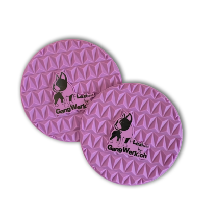 Two pink round dog toys with embossed geometric patterns designed for tactile stimulation. Featuring a black dog logo and the text "GangWerk.ch," these Flexiness SensiTarget toys by Your Whole Dog enhance your pup's perception.