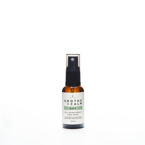 A small brown spray bottle labeled "Shy Tiger Soothe + Calm DAY Spray," by Your Whole Dog, contains 100 ml of calming Tasmanian lavender oil for dogs in a lavender and cucumber scent.