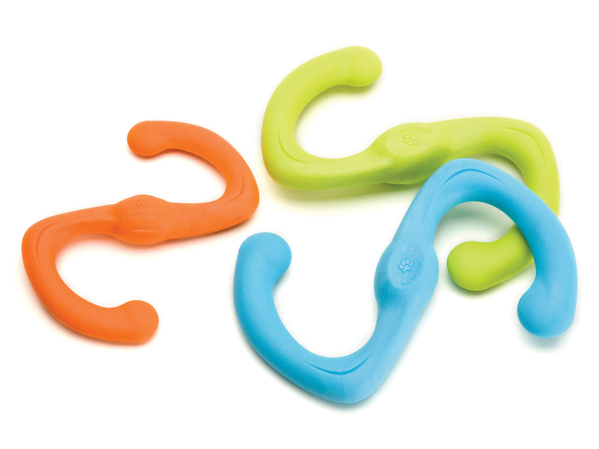 Three S-shaped West Paw Bumi rubber dog toys, by Your Whole Dog, in orange, green, and blue are flexibly arranged on a white background. This durable toy promises endless hours of tug-of-war fun.