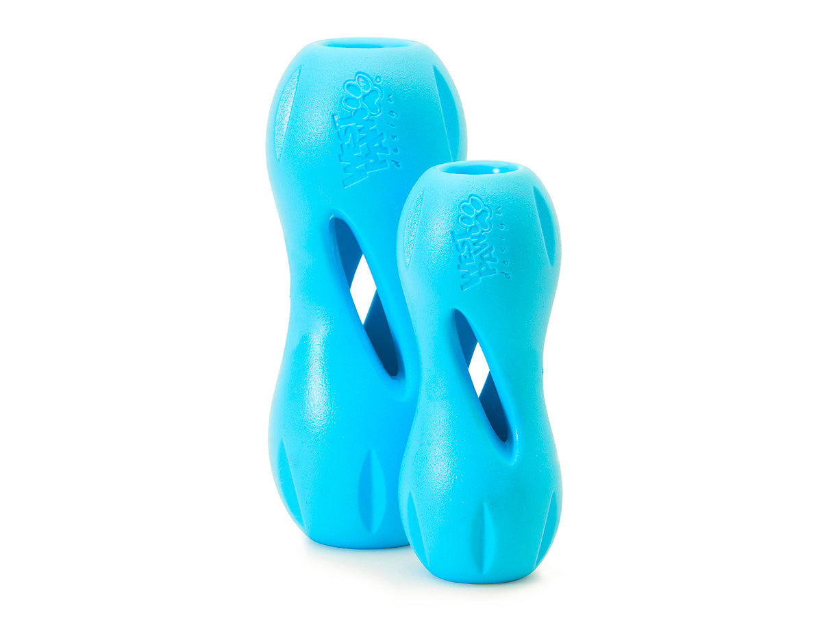 Two blue West Paw Qwizl dog toys from Your Whole Dog, available in two sizes, feature twisted hole designs ideal for tough chewers. These are treat dispensing and conveniently dishwasher safe.