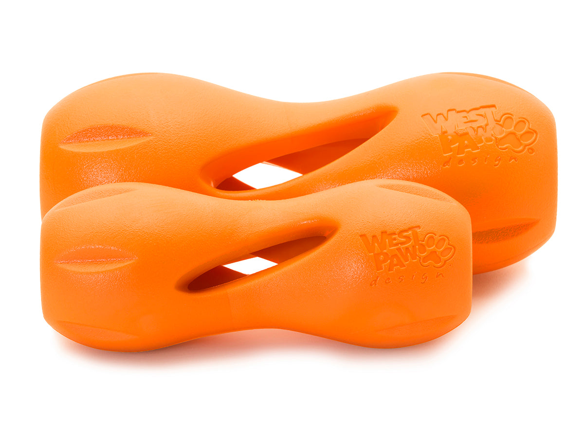 The orange West Paw Qwizl from Your Whole Dog, available in two sizes, is designed for tough chewers. Featuring an ergonomic shape with cut-out sections. These durable toys are also dishwasher safe, making clean-up easy.