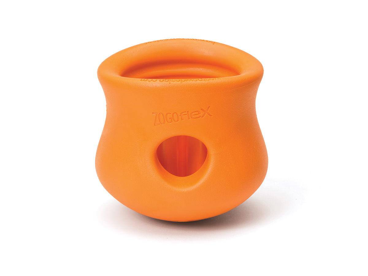 The West Paw Toppl is a durable orange rubber dog toy with an open top and side opening, perfect for holding treats.