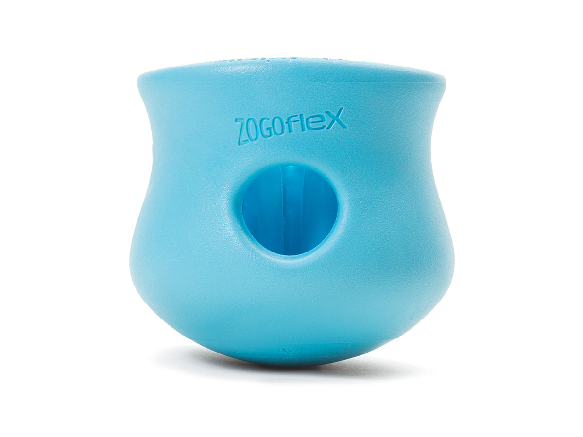 The durable West Paw Toppl, a blue dog toy by West Paw, has a rounded shape with a central hole, ideal for enrichment play or stuffing with treats.