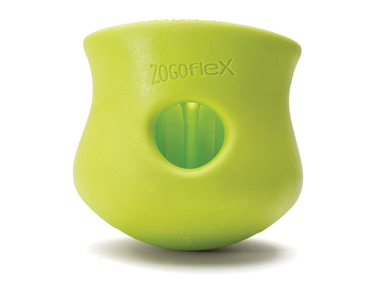 The durable West Paw Toppl from West Paw is a green rubber dog toy with a central hole for treats. This enrichment toy engages your pet's senses and provides hours of fun.