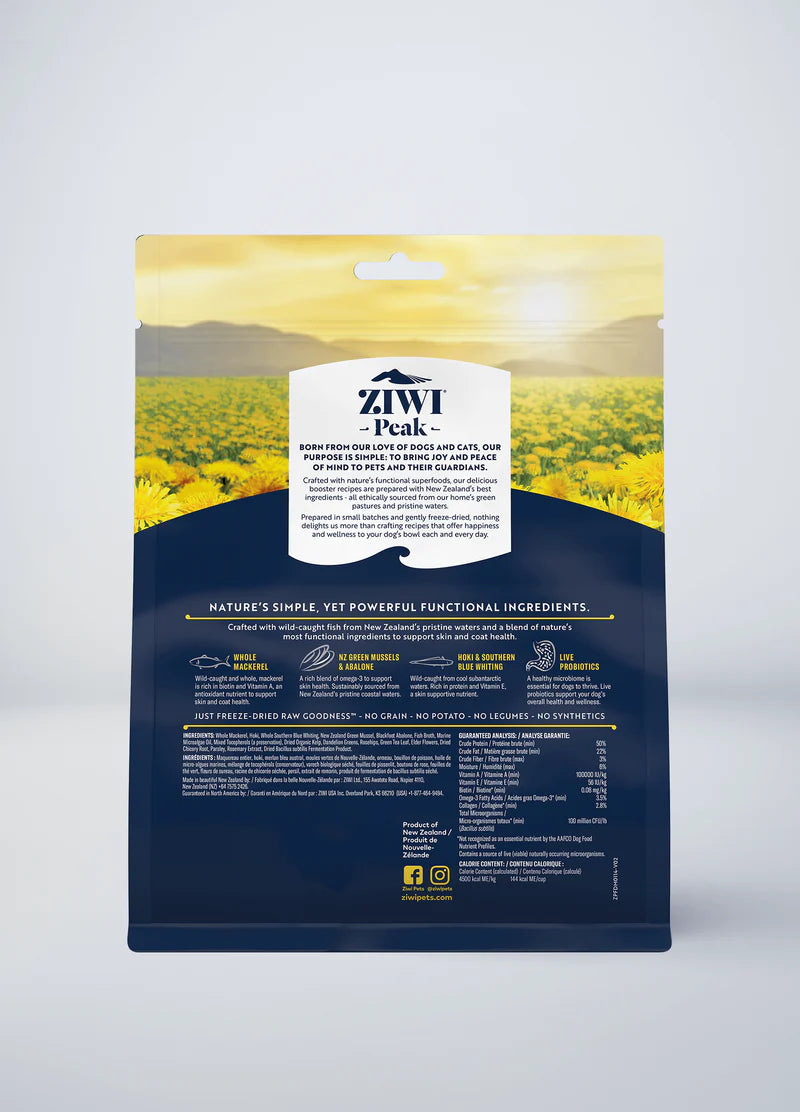 The back of the ZIWI Peak Freeze-Dried Booster - Skin & Coat Health package shows ingredients and nutrition details against hills on a yellow-green background, highlighting New Zealand green mussels for omega-3 and freeze-dried superfoods.