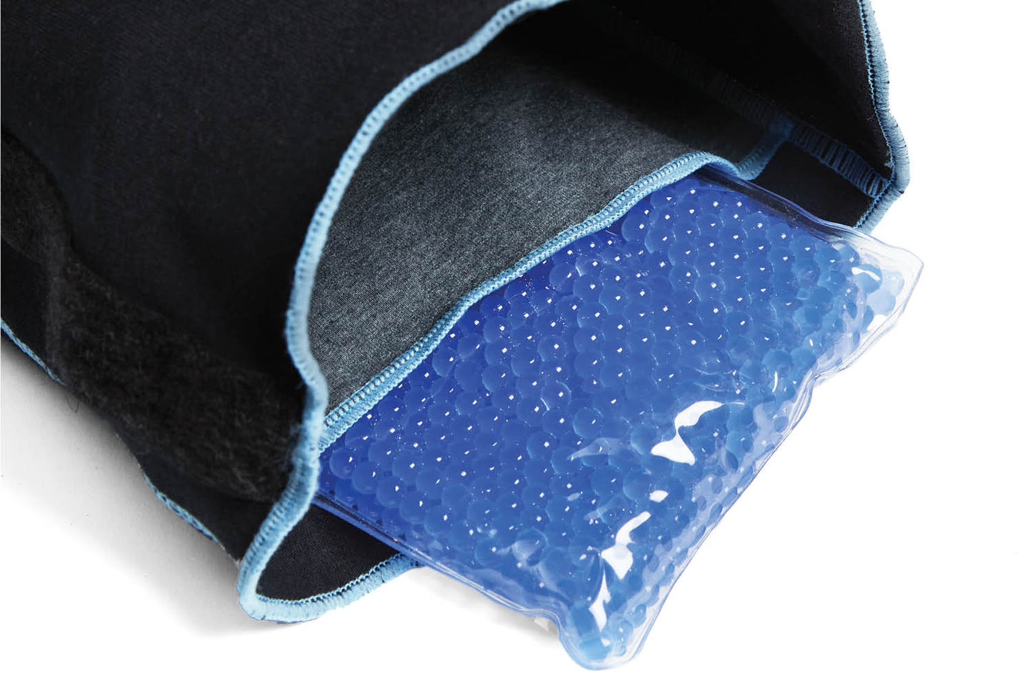 A black fabric cover with a zipper partially reveals a blue gel pack containing small beads, providing a dog-friendly option for soothing aches, is offered by Your Whole Dog's MediPaw Protective/Surgical Dog Suit.