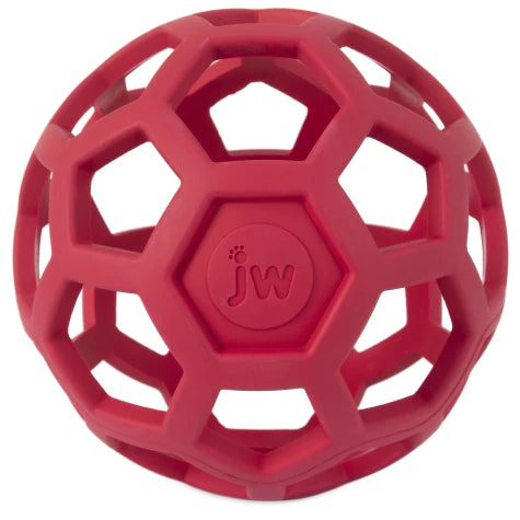 The JW Hol-ee Roller by Your Whole Dog is a red, spherical ball made from durable rubber featuring a hexagonal lattice design and an engraved central logo.