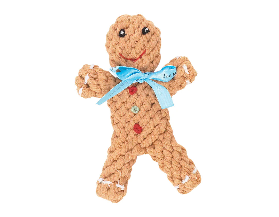 The Jax & Bones Gingerbread 6" Rope Toy by Jax & Bones - Rope Toys is a gingerbread man-shaped, natural cotton rope dog toy with blue ribbon, embroidered face, and buttons—great as a playful dental chew for your pup.