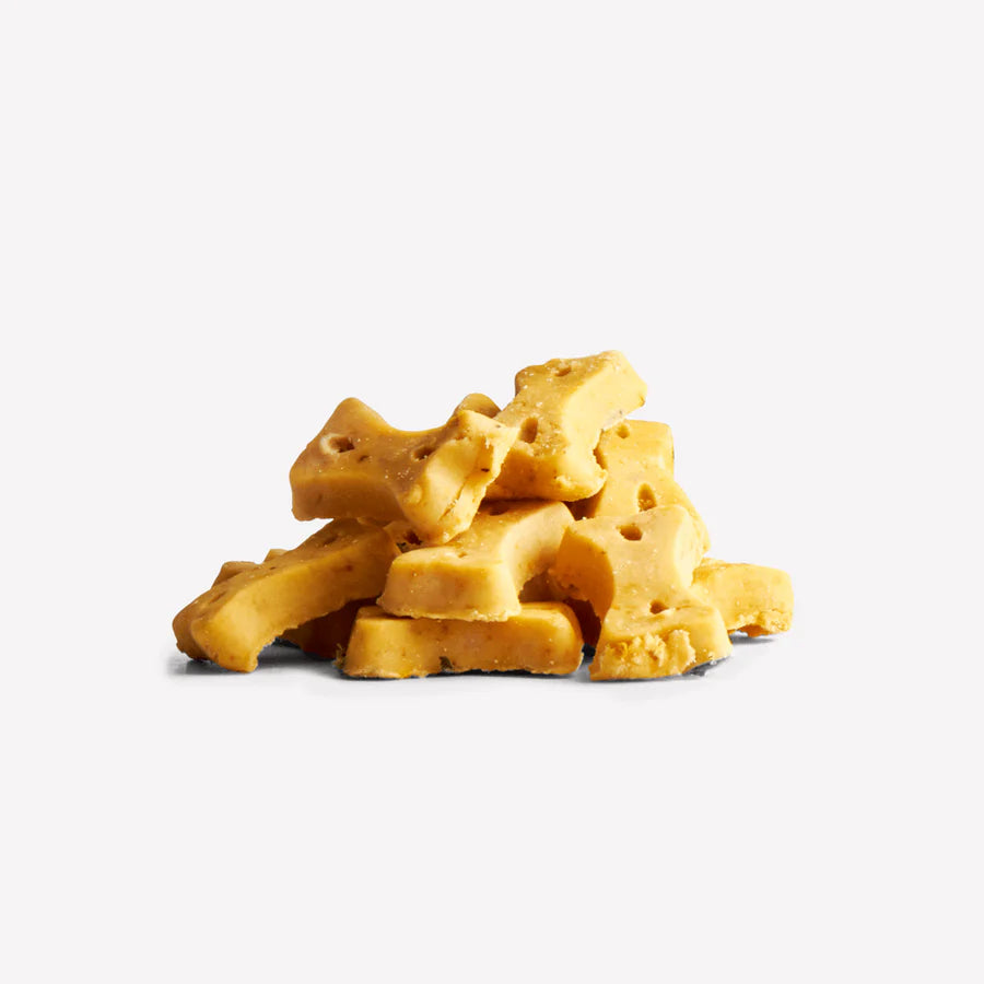 A stack of Beco Pets Cashew Dog Treats with Pumpkin Seed & Carrot from Your Whole Dog is arranged on a plain white background.