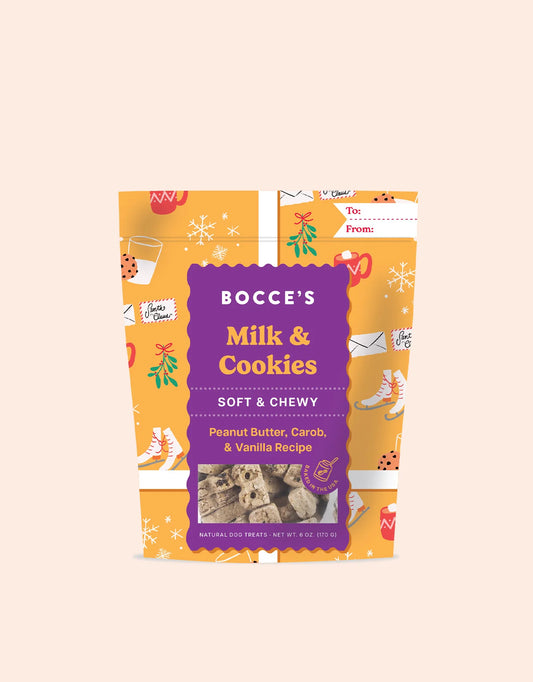 Your Whole Dog offers Bocce's Bakery Milk & Cookies Soft & Chewy Christmas Treats, featuring a delightful peanut butter, carob, and vanilla recipe. These wheat-free treats come in vibrant orange packaging with festive holiday designs, reminiscent of classic Christmas cookies.