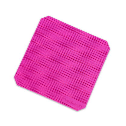 A pink Flexiness FlexBlox mat with stackable holes on it by Your Whole Dog.