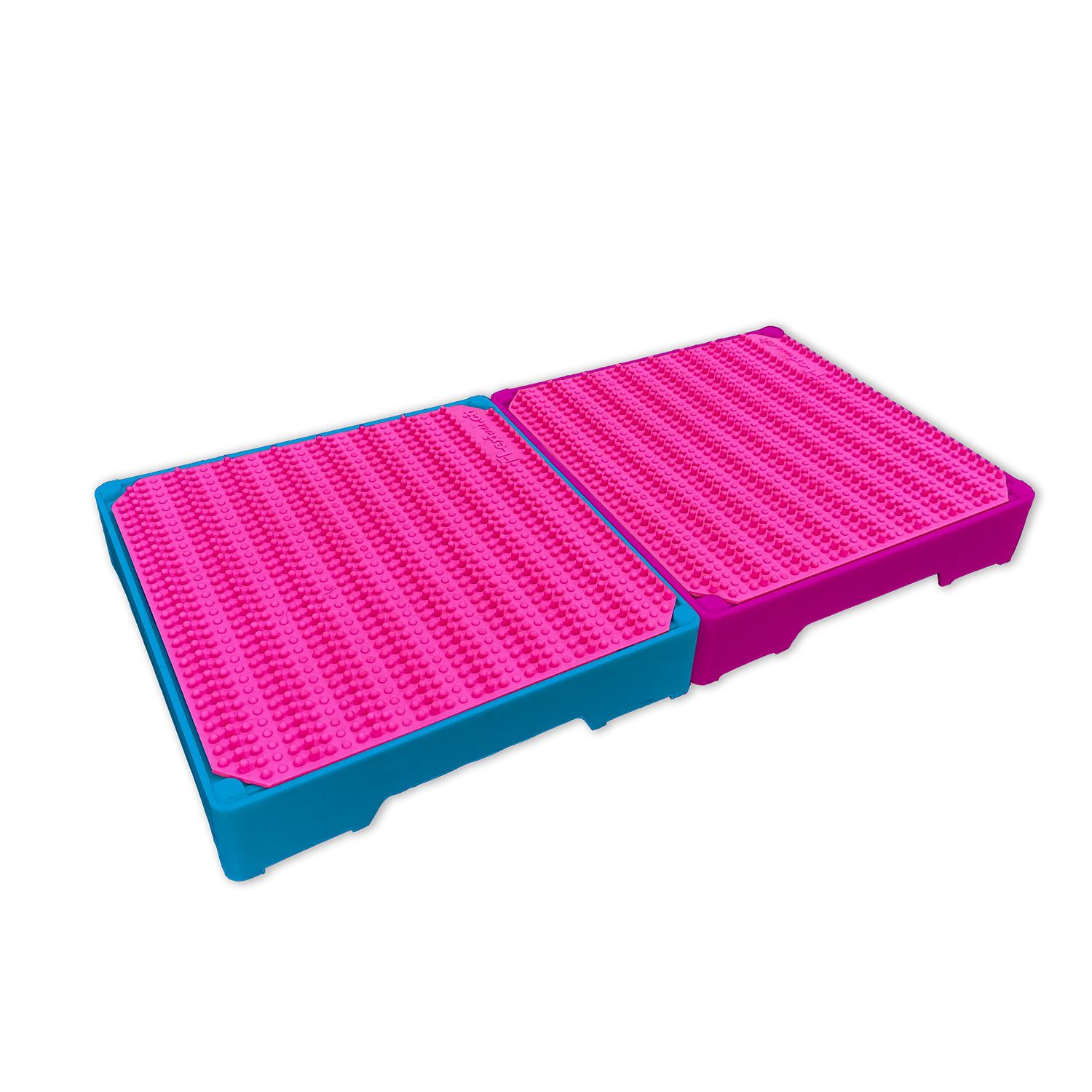 Two stackable pink and blue PVC mats on top of each other, known as Flexiness FlexBlox by Your Whole Dog.