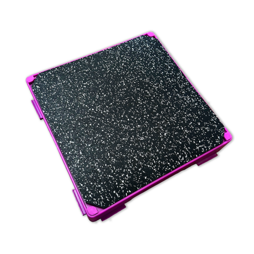 The Flexiness FlexBloxMat - PRE-ORDER by Your Whole Dog is a square, black, textured mat with purple edges and corners that enhances your training experience with its unique sensory effects.