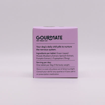 A pink box adorned with the "Your Whole Dog" brand showcases information about the "Chill With L-Tryptophan for Natural Mood Support" pet treat by Gourmate Pet Treat Co., highlighting its premium ingredients, such as New Zealand marine collagen, and providing clear dosage instructions.