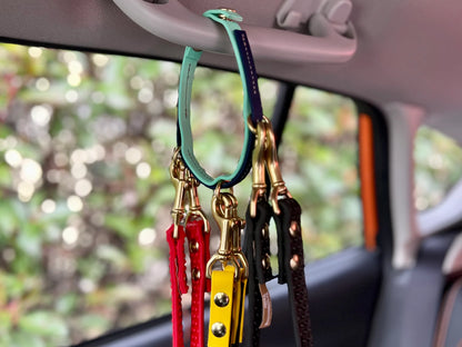 A Trailblazing Tails: The Leash Organiser hangs from the rearview mirror of a car, made by Your Whole Dog.