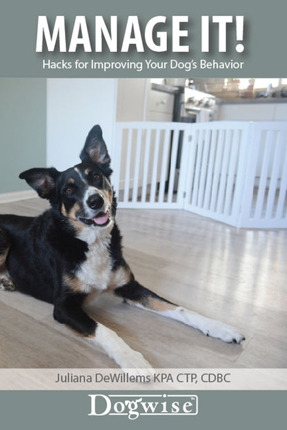A black and tan dog lies on a wooden floor in front of a white gate; text reads "Book: Manage It! Hacks for Improving Your Dog’s Behavior" by Juliana De Willems, from Your Whole Dog.