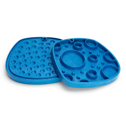 Two West Paw Feast Mats from Your Whole Dog, available in blue. They feature various circular indents and raised sections and are crafted from recycled ocean-bound plastic