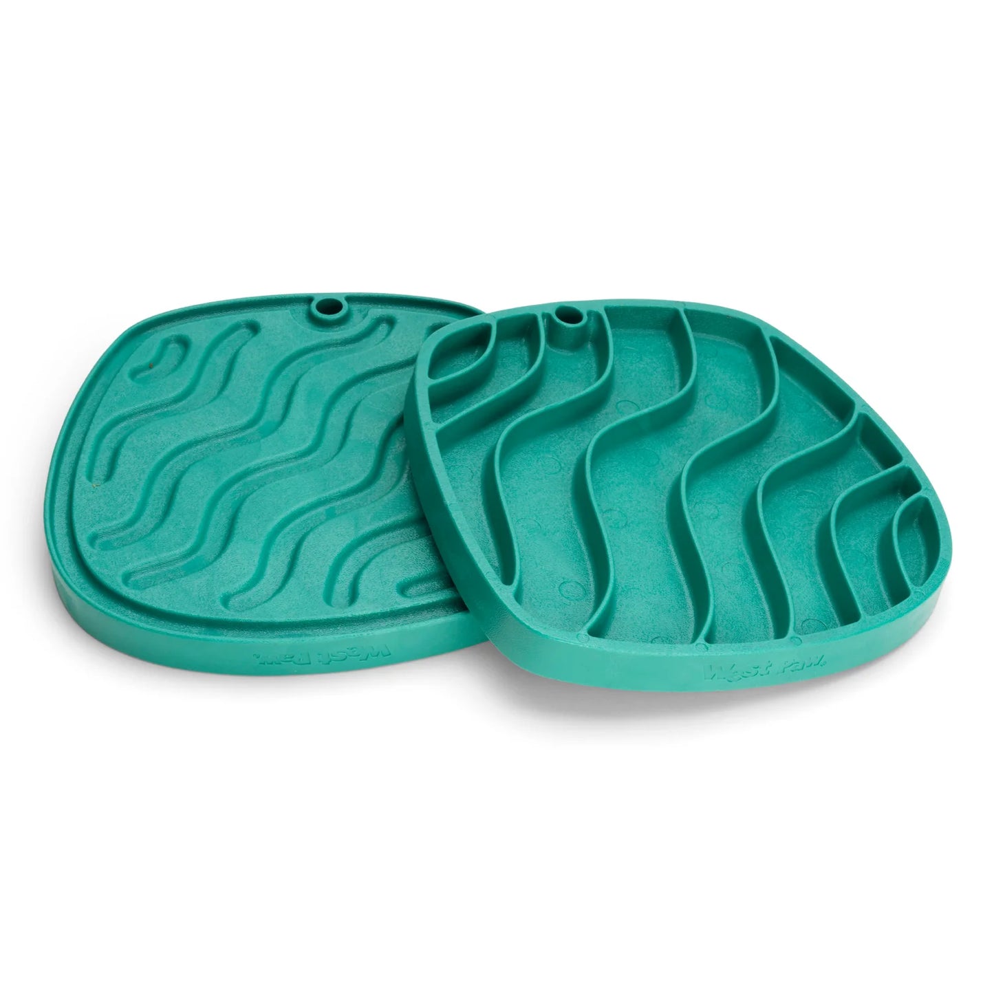 The West Paw Feast Mats from Your Whole Dog, are made from recycled ocean-bound plastic and feature a wavy groove design. Two mats are stacked on top of each other.