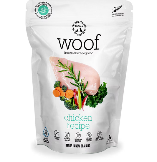 A package of WOOF Freeze Dried Chicken Dog Food by WOOF - The NZ Natural Petfood Co, with raw chicken breast, vegetables, and herbs on the front to showcase its natural ingredients.