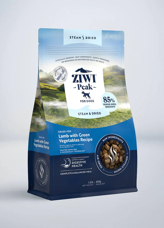 A package of Your Whole Dog's ZIWI Peak: Steam & Dried Lamb with Green Vegetables Recipe dog food showing nutritional information and picturesque landscape background.