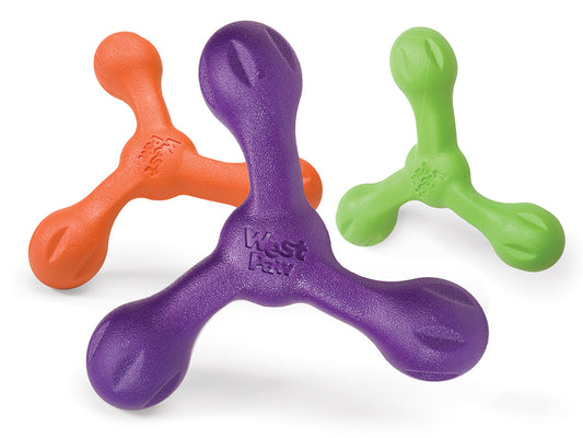 Three West Paw Skamp fetch toys, shaped like jacks and shown in orange, purple, and green, display the "West Paw" logo on the durable purple dog toy.