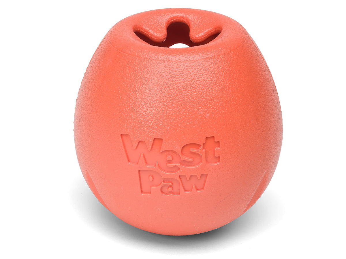 An orange West Paw Rumbl from Your Whole Dog. A treat-dispensing dog chew toy, shown on a white background.