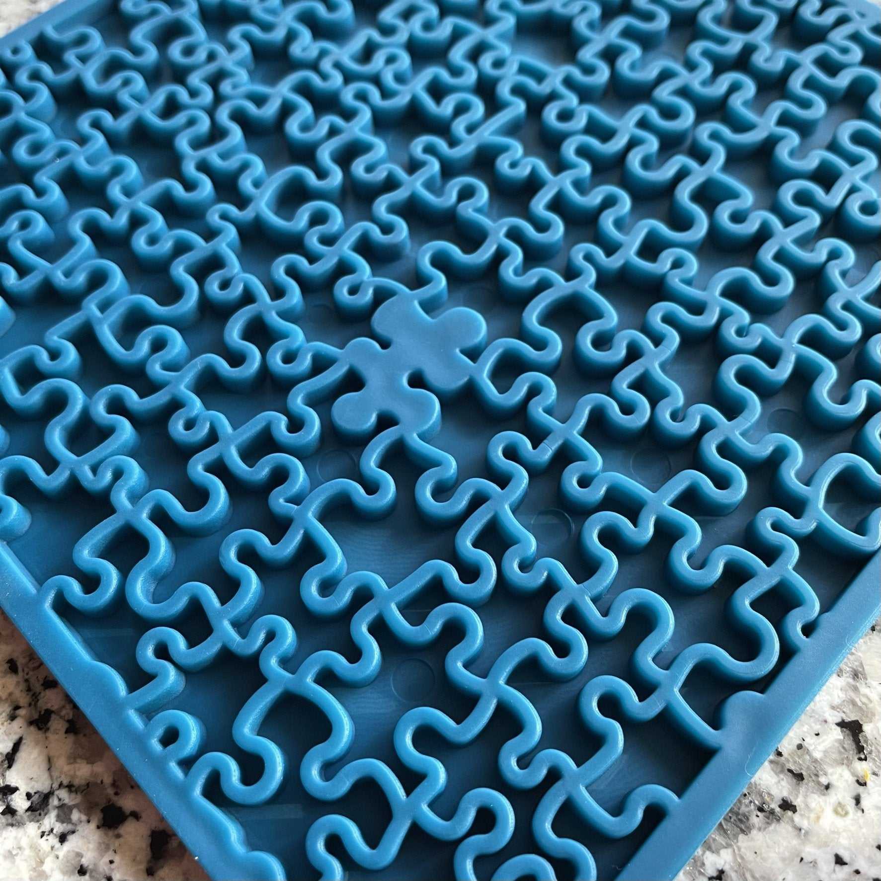 Blue Soda Pup silicone trivet with interlocking puzzle piece design, ideal as Soda Pup EMAT ENRICHMENT LICKING MATs from Your Whole Dog.