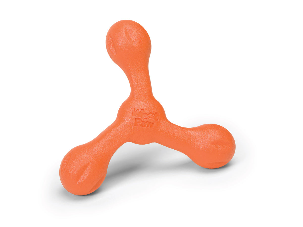 An orange West Paw Skamp tough dog toy with three rounded prongs and "West Paw" embossed in the center is shown on a white background.